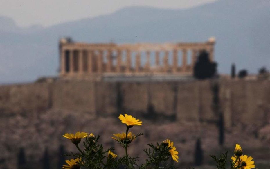 Parthenon in Athens, Greece, with spring flowers blooming.
